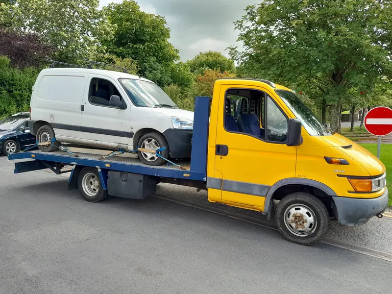 Van on a recovery truck collected for scrap near Windermere